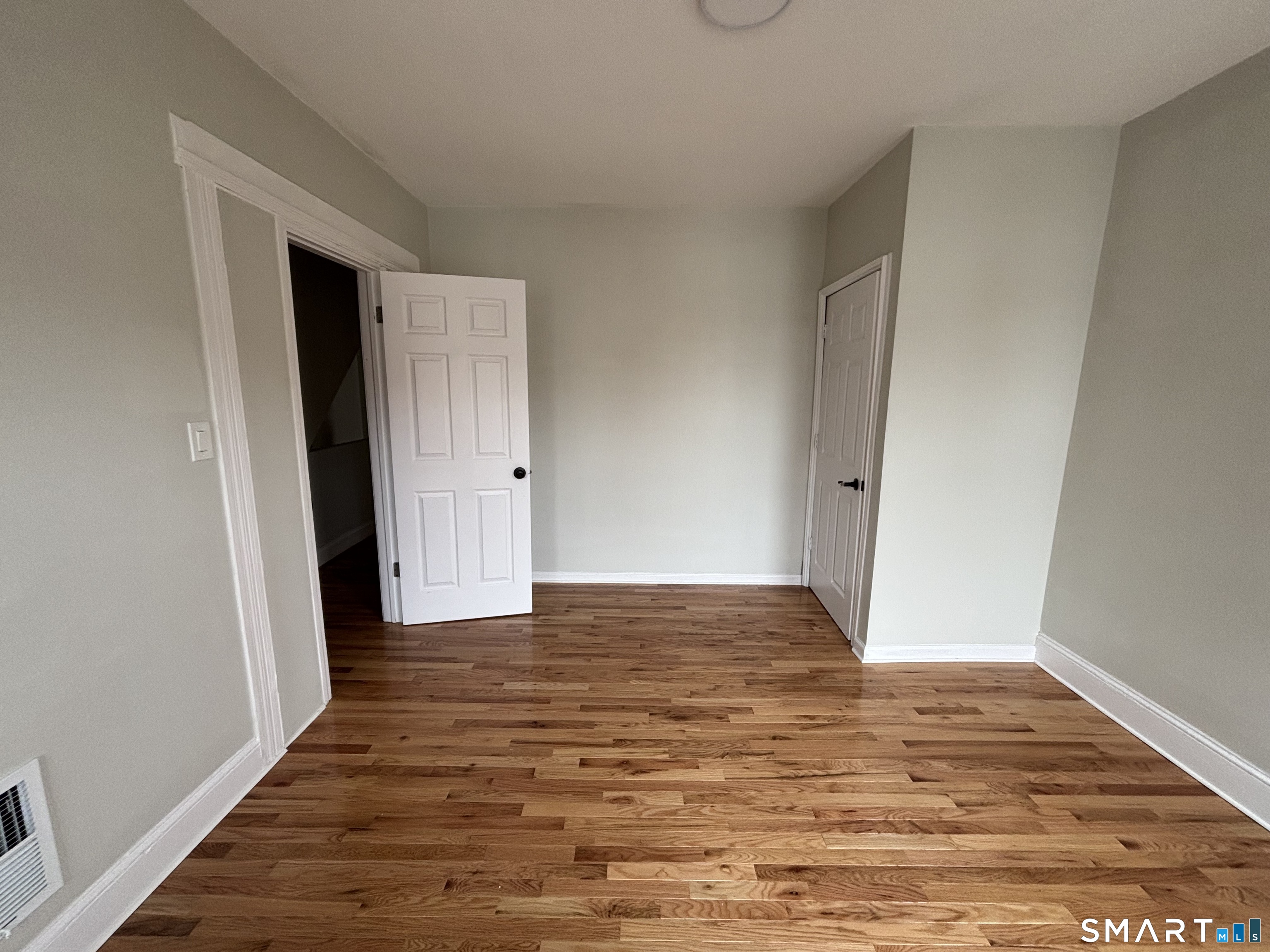 241 Lewis Street Bridgeport, CT 06605 - Photo 17 of 33 a view of an empty room with wooden floor