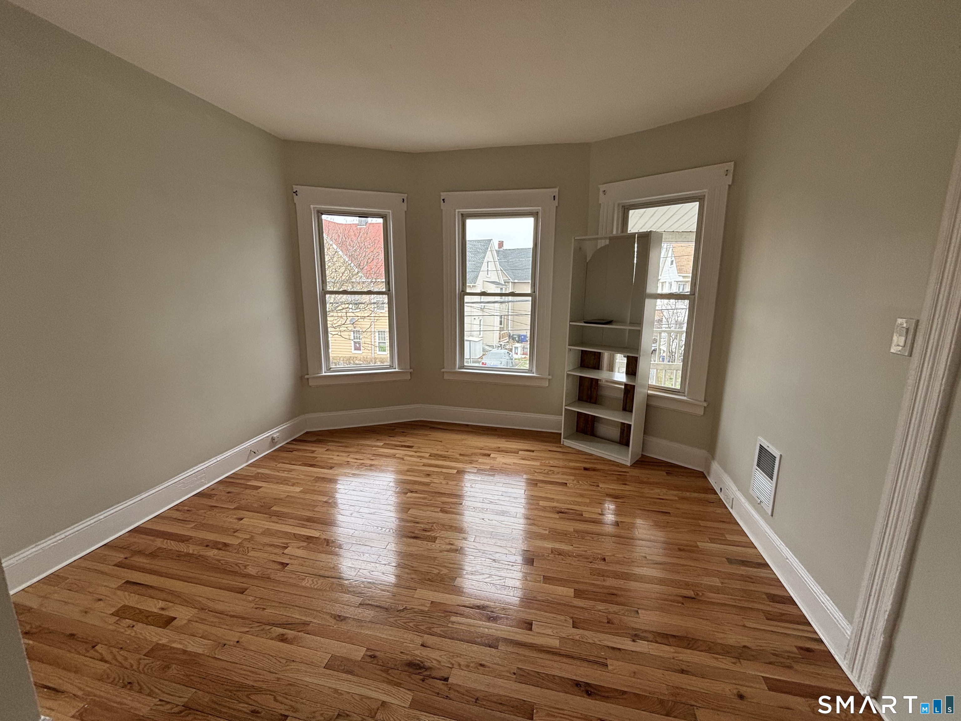 241 Lewis Street Bridgeport, CT 06605 - Photo 18 of 33 a view of empty room with wooden floor and fan