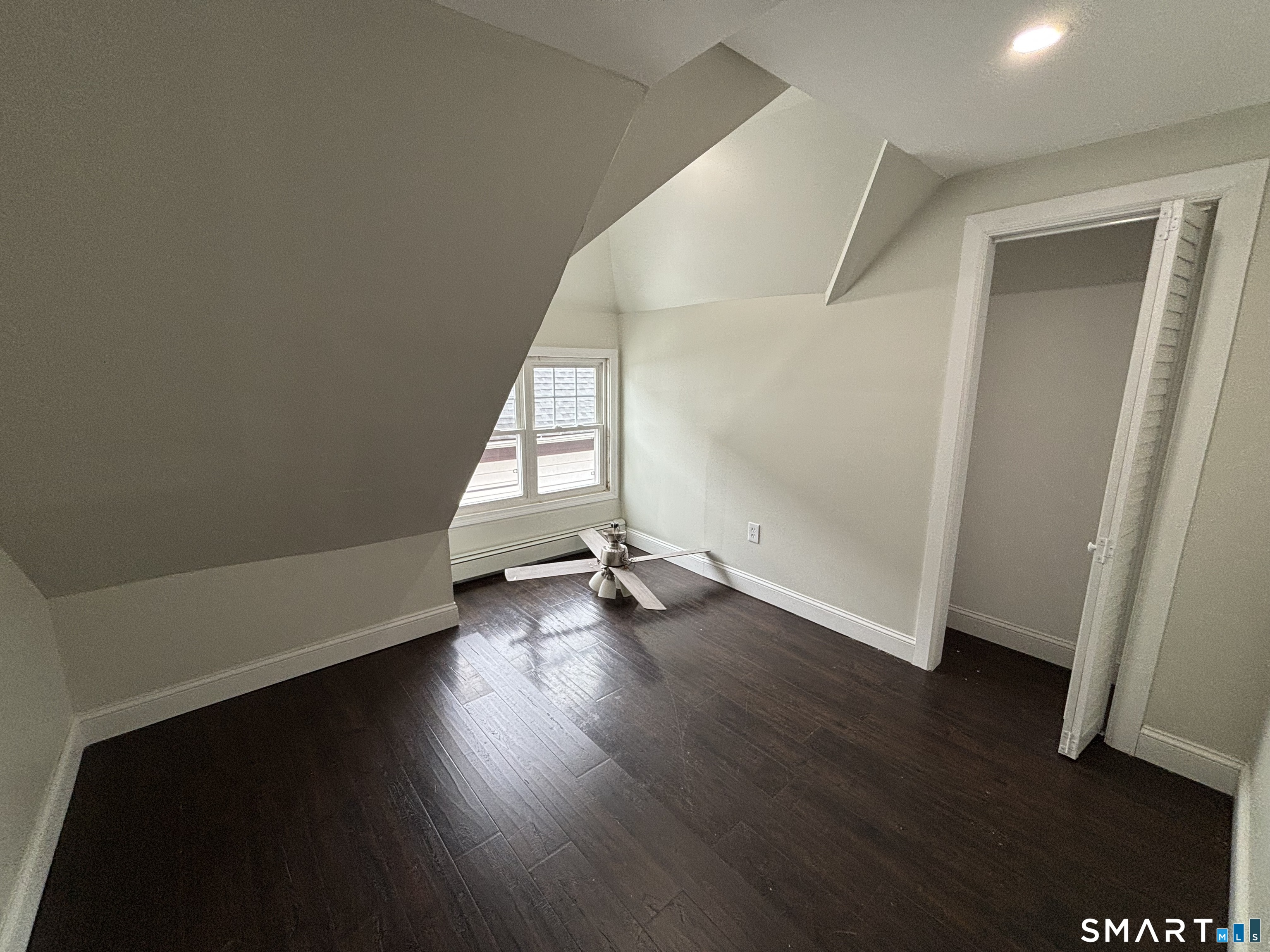 241 Lewis Street Bridgeport, CT 06605 - Photo 22 of 33 an empty room with wooden floor and windows