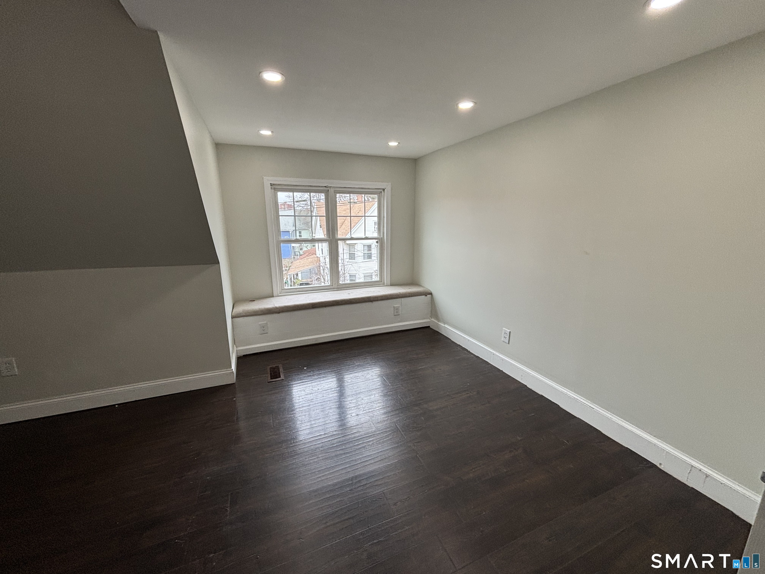 241 Lewis Street Bridgeport, CT 06605 - Photo 23 of 33 an empty room with wooden floor and windows