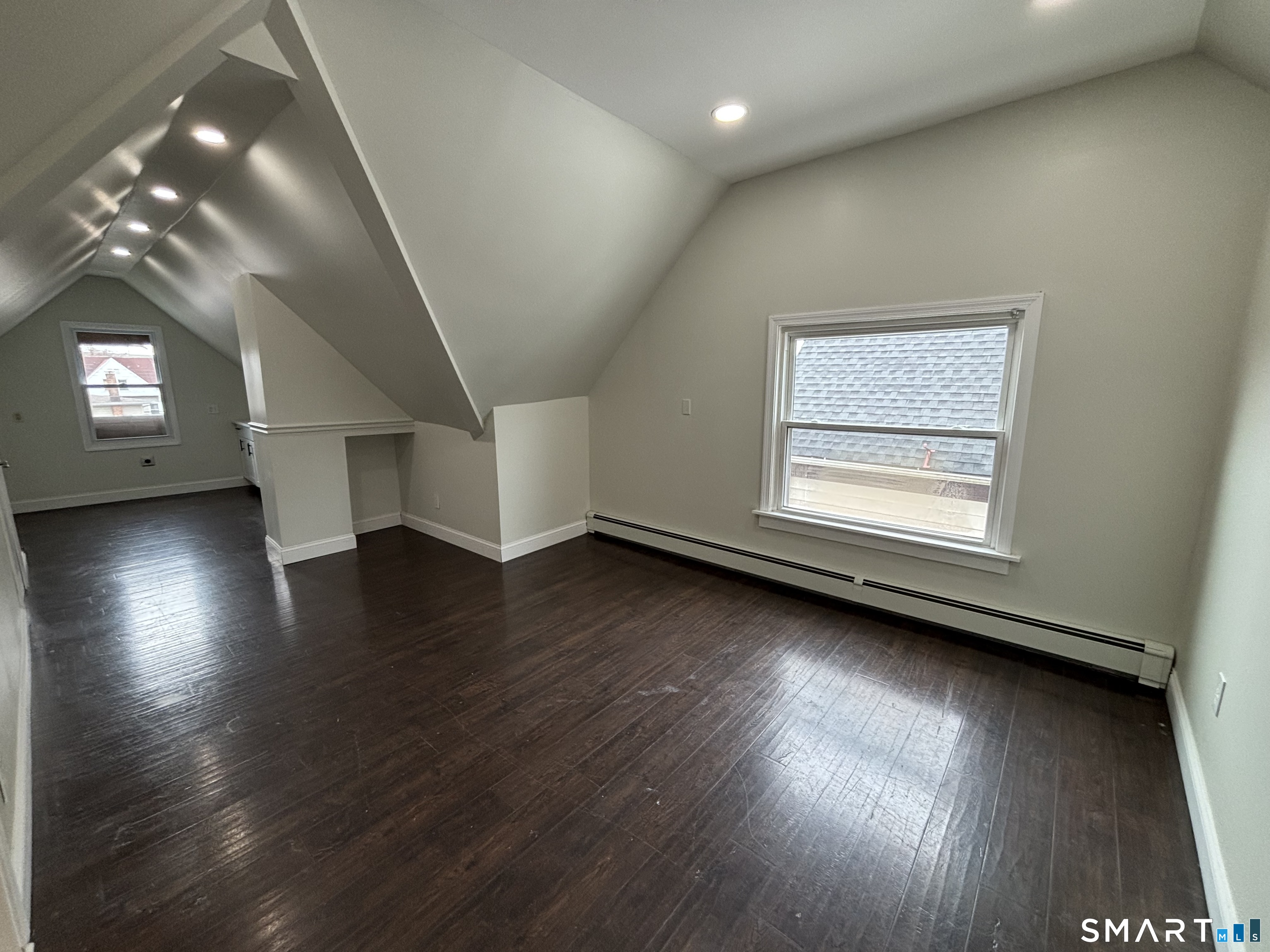 241 Lewis Street Bridgeport, CT 06605 - Photo 28 of 33 an empty room with wooden floor and windows