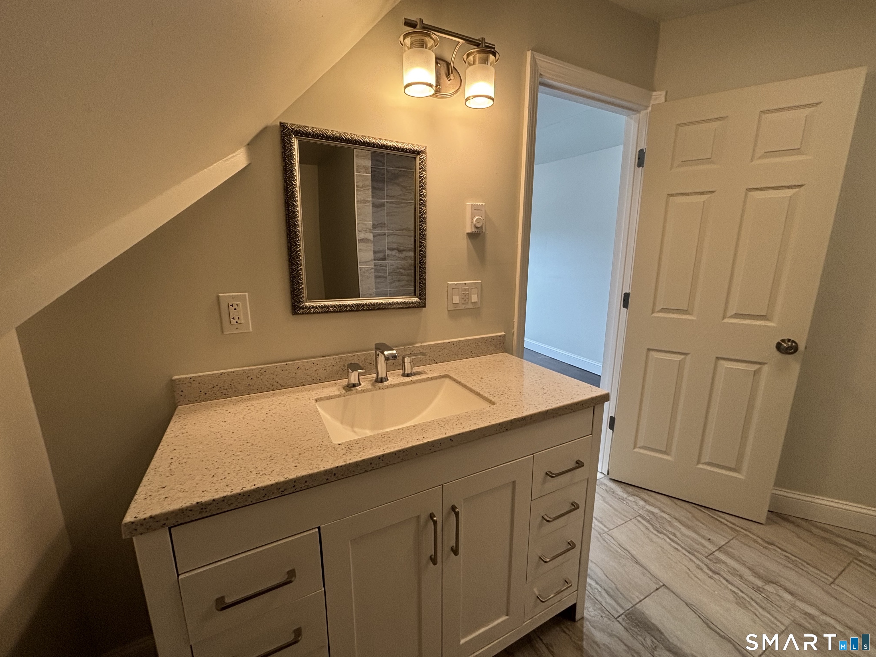241 Lewis Street Bridgeport, CT 06605 - Photo 31 of 33 a bathroom with a sink and a mirror