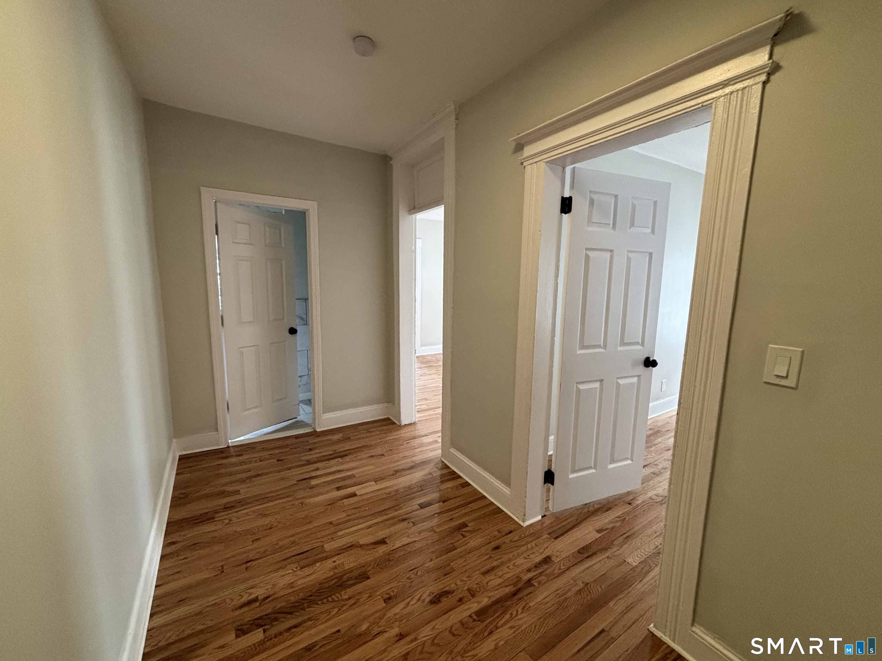 241 Lewis Street Bridgeport, CT 06605 - Photo 4 of 33 a view of a hallway with wooden floor