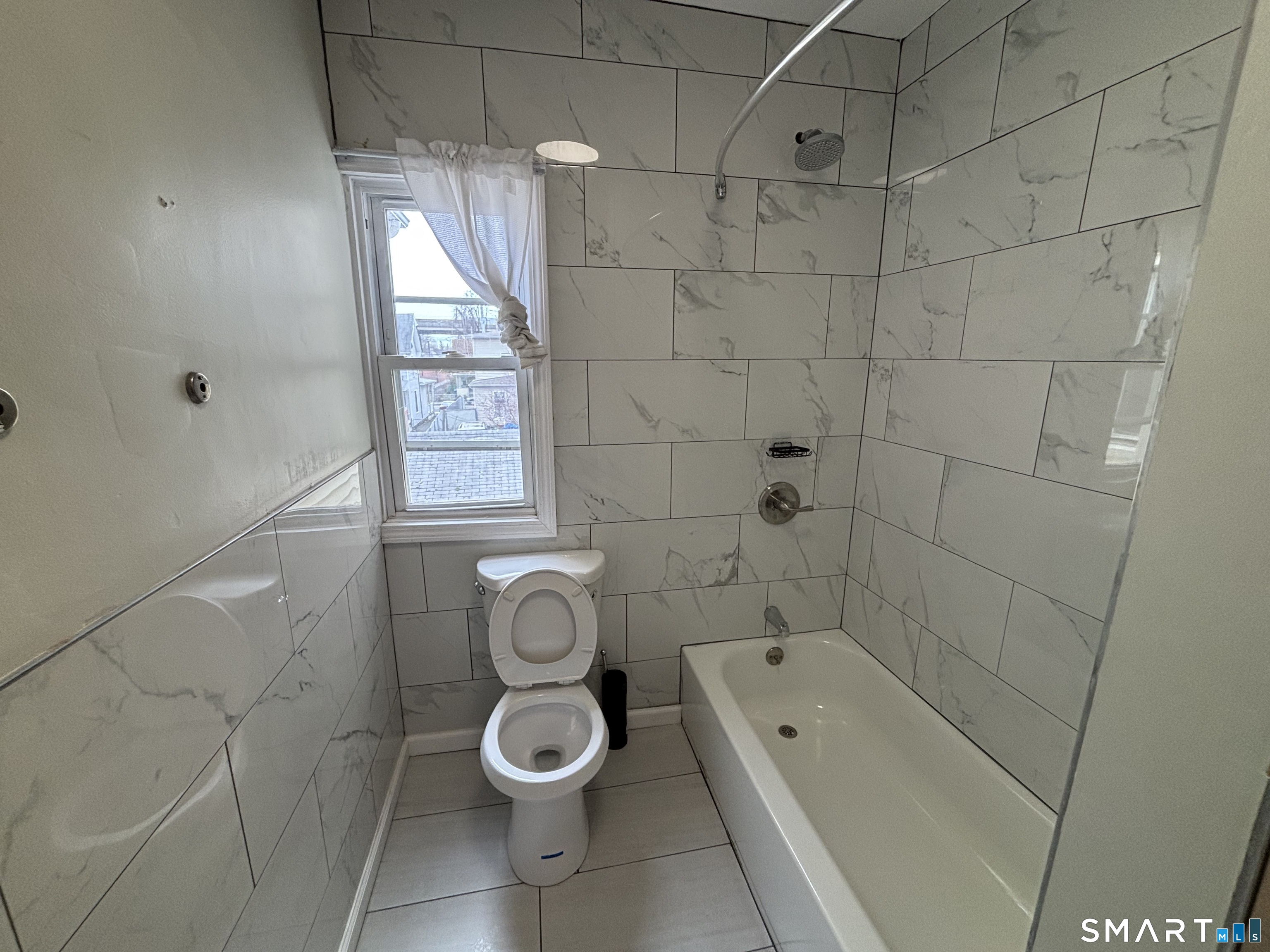241 Lewis Street Bridgeport, CT 06605 - Photo 7 of 33 a bathroom with a toilet and a bathtub