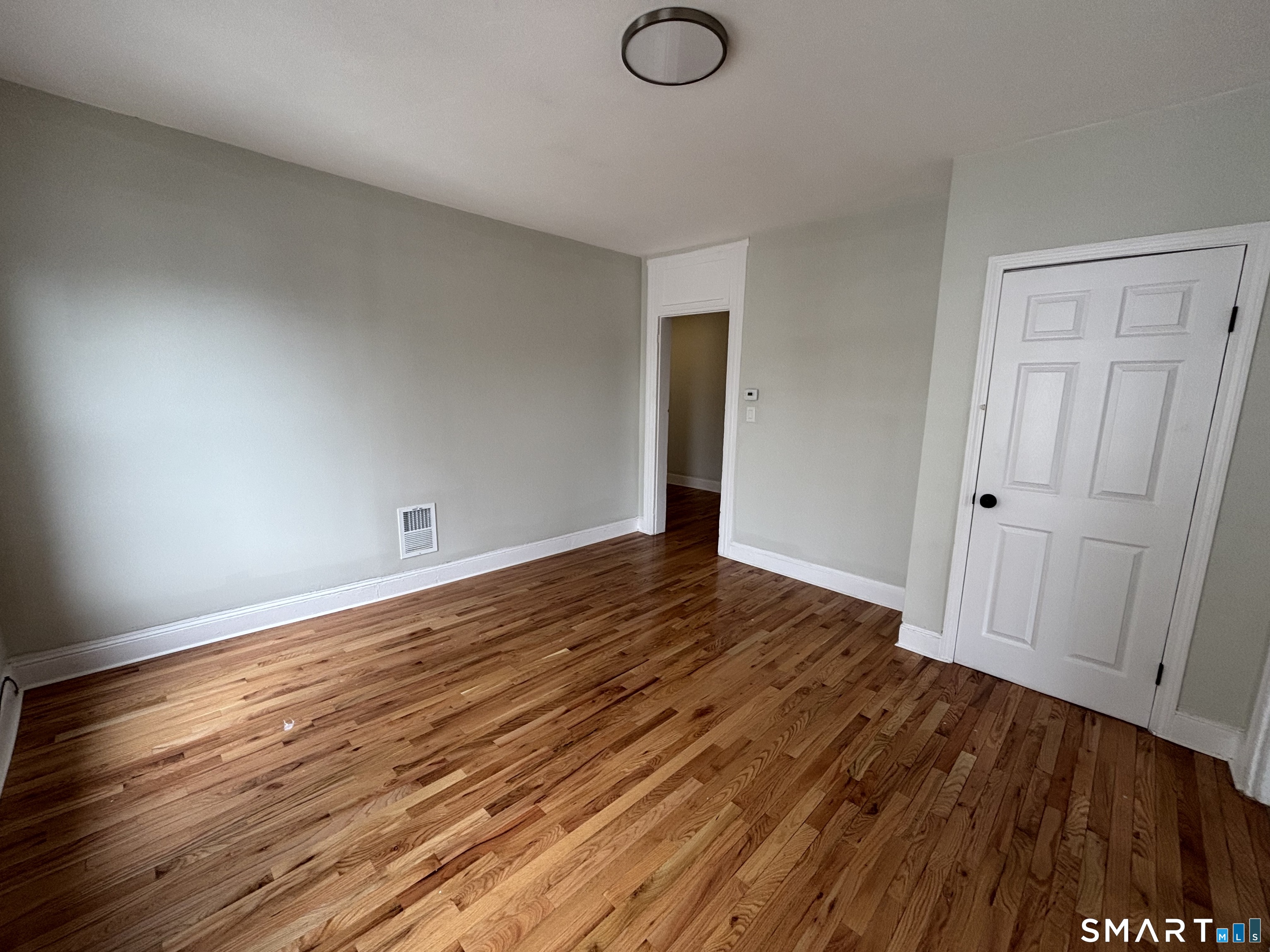 241 Lewis Street Bridgeport, CT 06605 - Photo 10 of 33 a view of a room with wooden floor