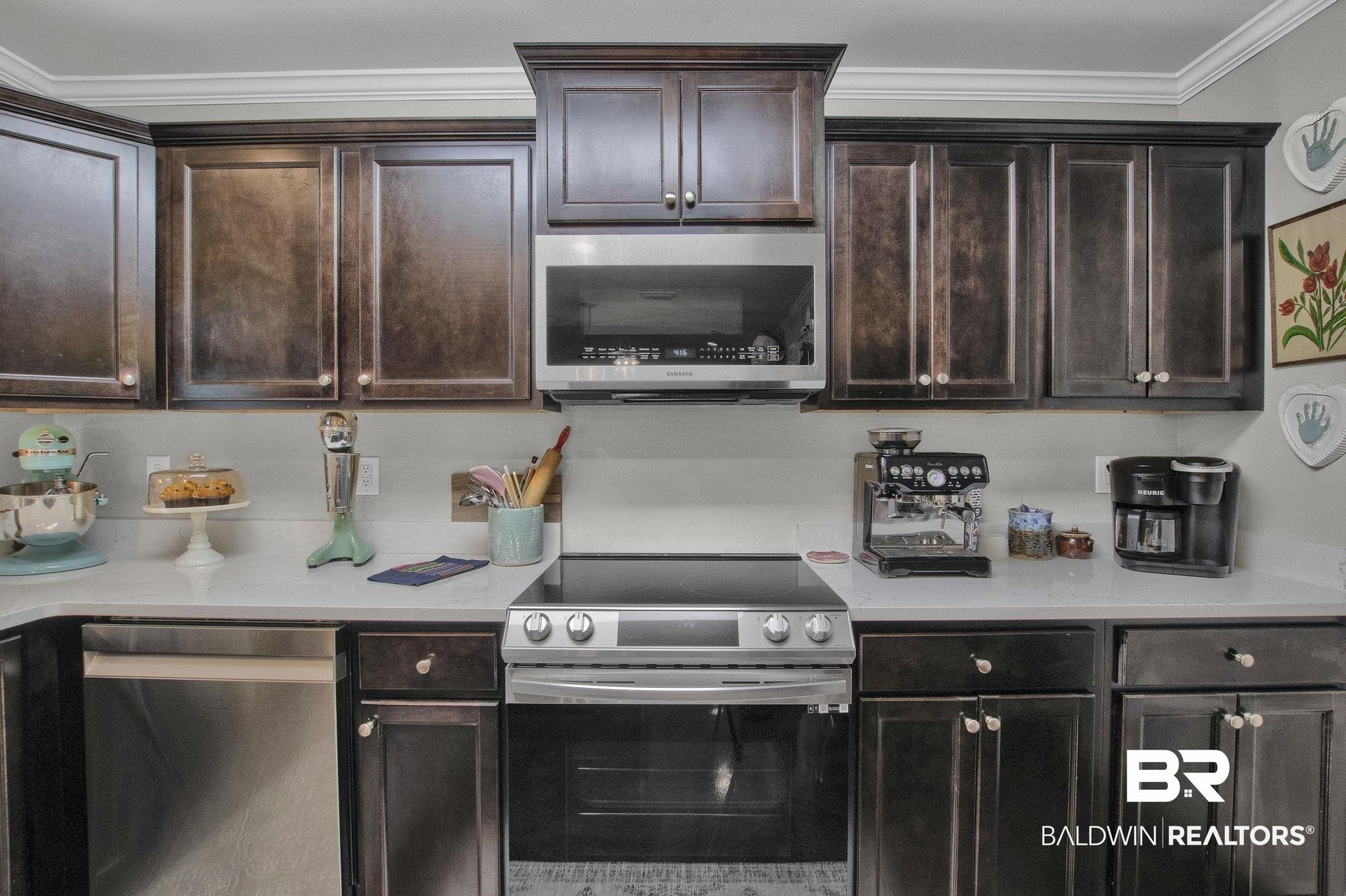 203 Lakefront Circle Summerdale, AL 36580 - Photo 25 of 69 Kitchen with ornamental molding, appliances with stainless steel finishes, and dark brown cabinetry
