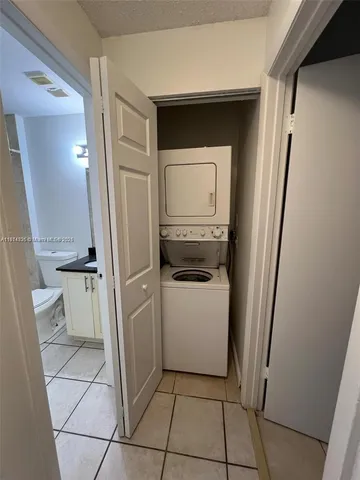 a utility room with cabinets washer and dryer