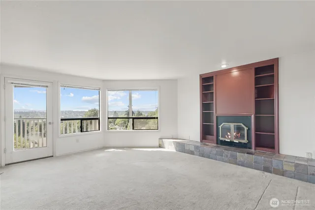 a view of a livingroom with an empty space and a fireplace