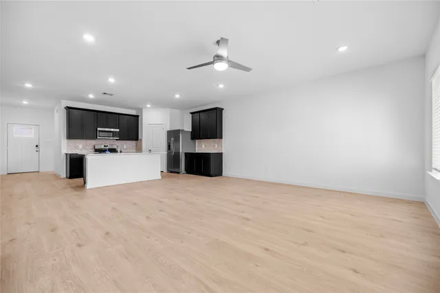a view of kitchen with a sink a refrigerator and a microwave