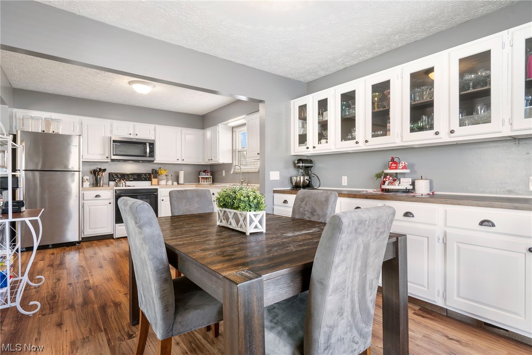801 Netherwood Avenue Northwest Canton, OH 44708 - Photo 13 of 44 Dining space with lvt wood-type flooring, a textured ceiling, and perfect countertop for displaying all your food dishes.