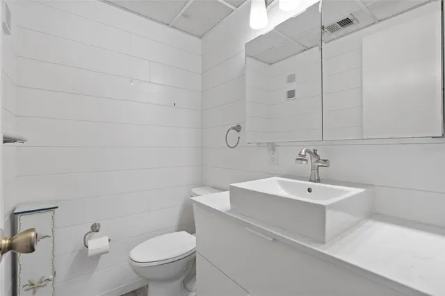 a white toilet sitting next to a bathroom sink