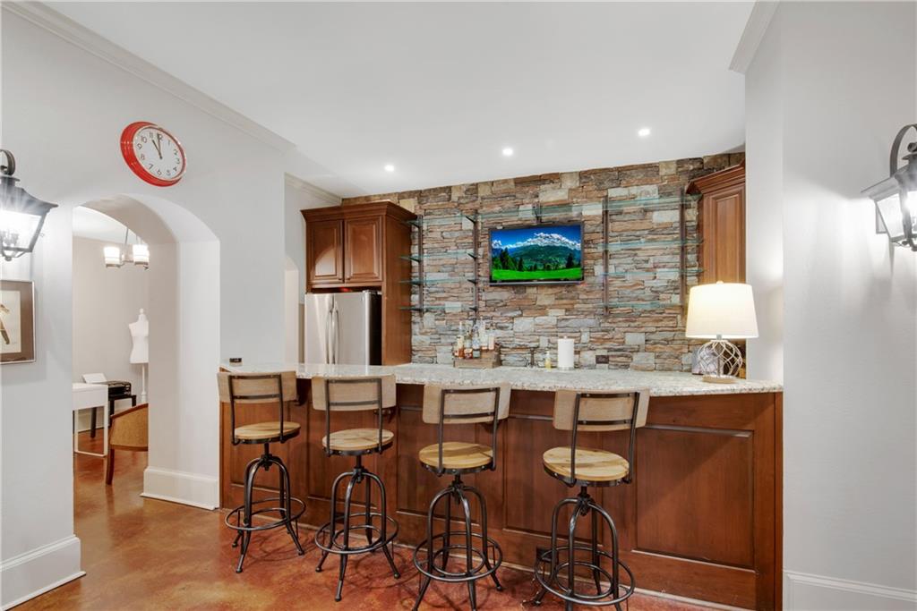 13942 Tree Loft Road Milton, GA 30004 - Photo 65 of 102 a kitchen with stainless steel appliances a dining table and chairs
