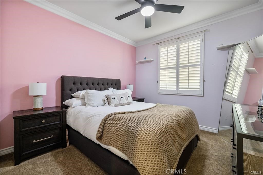 28537 Vista Del Rio Drive Valencia, CA 91354 - Photo 18 of 31 a bedroom with a bed and a chandelier