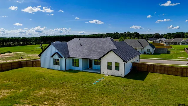 a kitchen with kitchen island granite countertop a sink and wooden floor