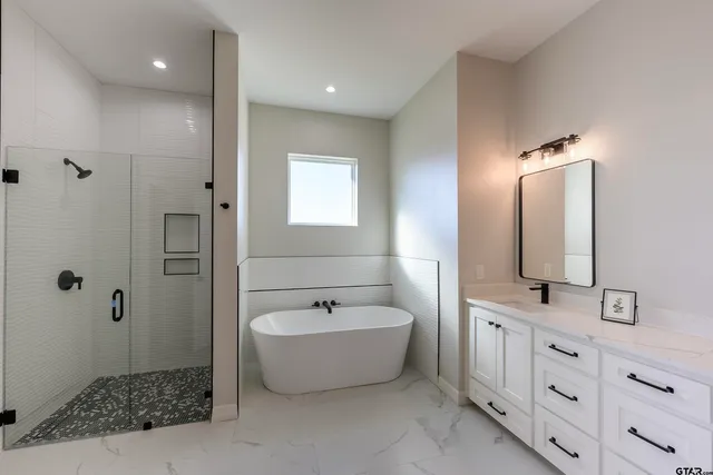 a bathroom with a bathtub and shower