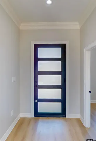 a view of a kitchen with refrigerator and wooden floor