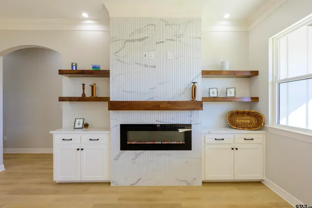 a view of a kitchen with wooden floor and a window