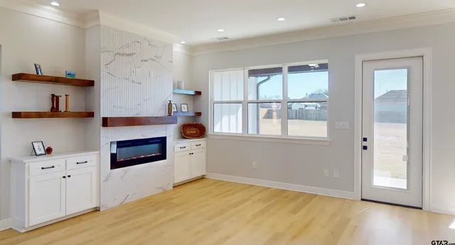 a living room with fireplace furniture and a wooden floor