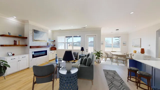 a kitchen with kitchen island a sink stainless steel appliances and a chandelier