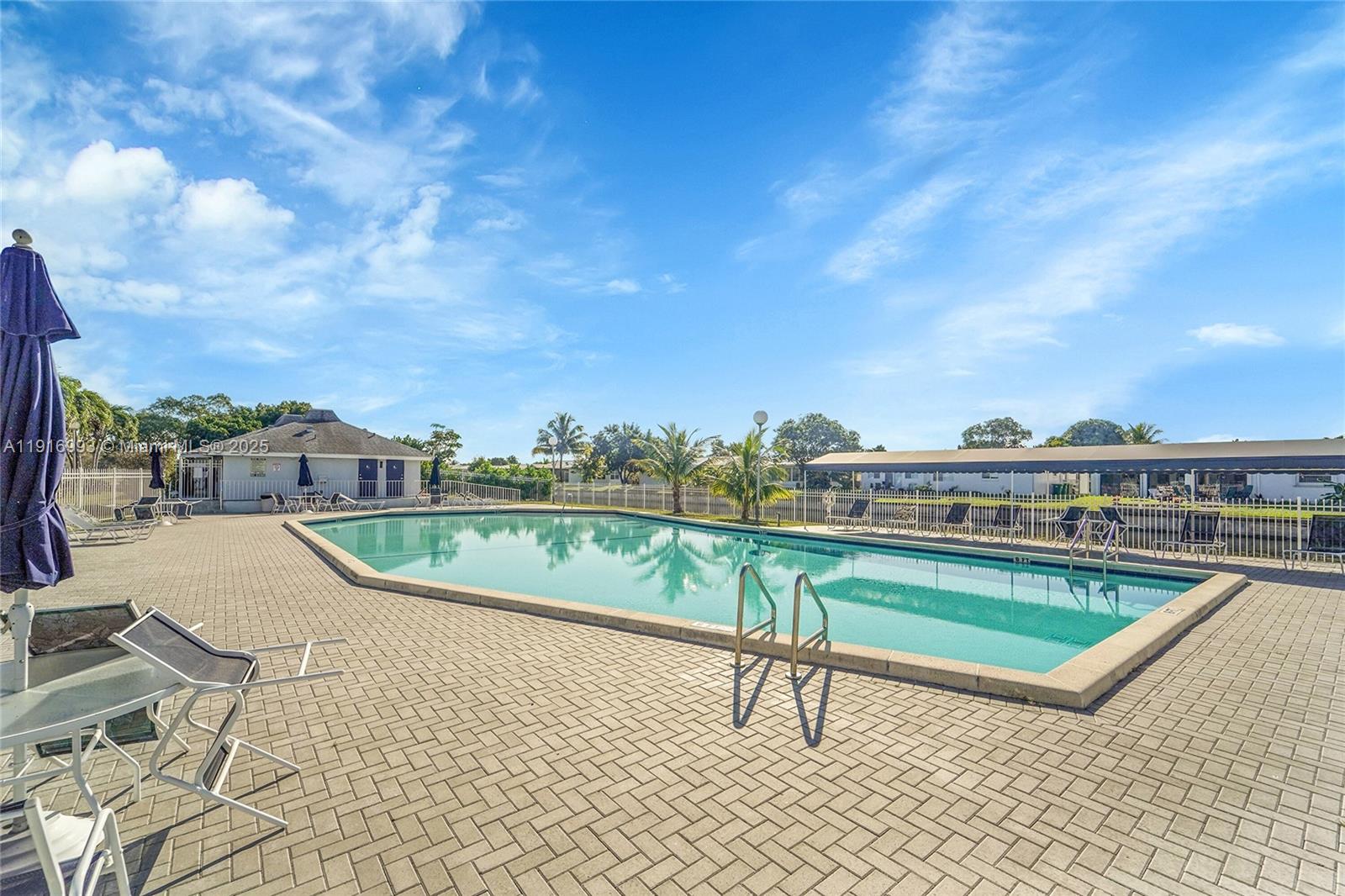 8405 Northwest 61st Street, Unit D207 Tamarac, FL 33321 - Photo 16 of 28 a view of swimming pool with a terrace