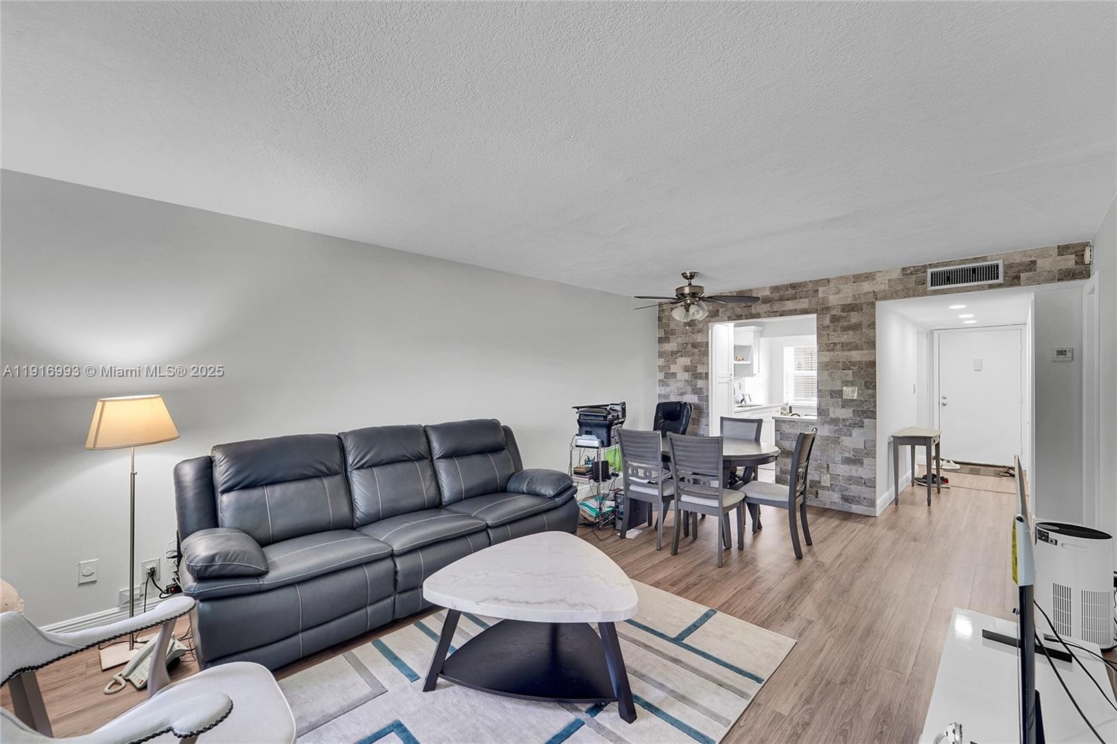 8405 Northwest 61st Street, Unit D207 Tamarac, FL 33321 - Photo 2 of 28 a living room with furniture and a large window