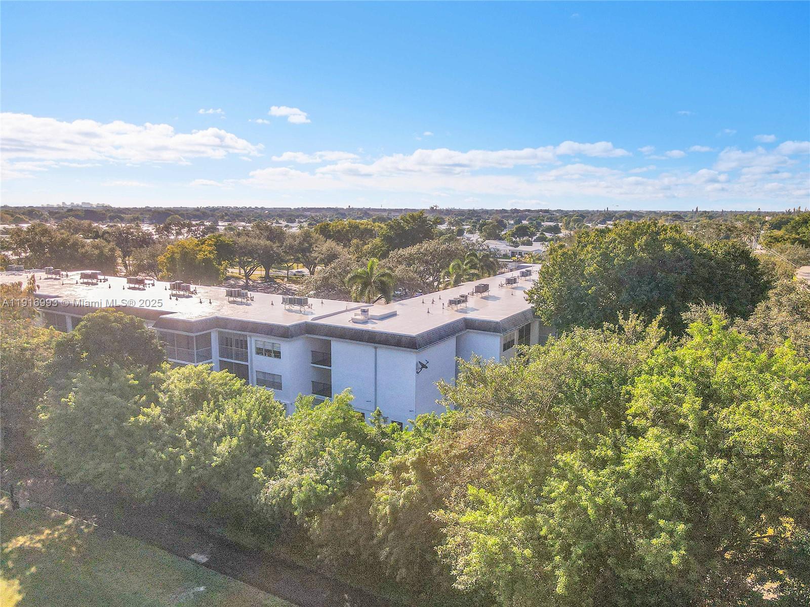 8405 Northwest 61st Street, Unit D207 Tamarac, FL 33321 - Photo 22 of 28 a view of a lake with a building