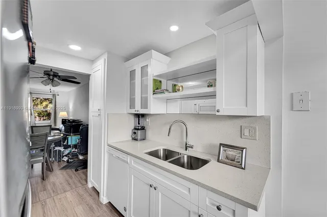 a kitchen with stainless steel appliances a sink stove and cabinets