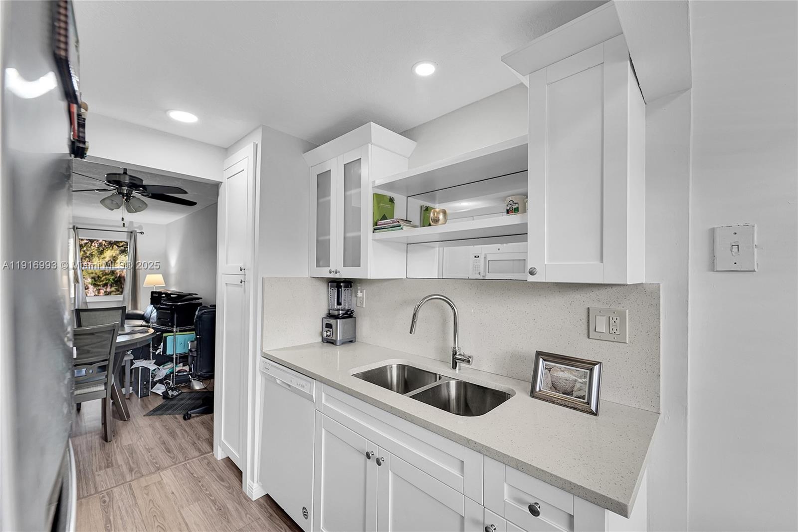 8405 Northwest 61st Street, Unit D207 Tamarac, FL 33321 - Photo 4 of 28 a kitchen with stainless steel appliances a sink stove and cabinets