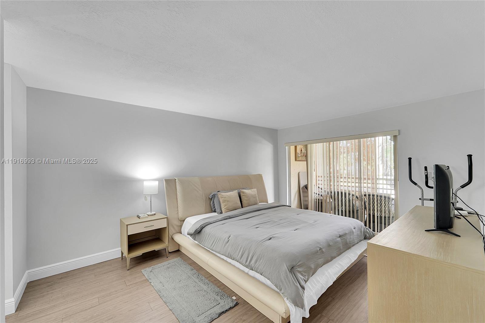 8405 Northwest 61st Street, Unit D207 Tamarac, FL 33321 - Photo 7 of 28 a bedroom with a bed and a large window