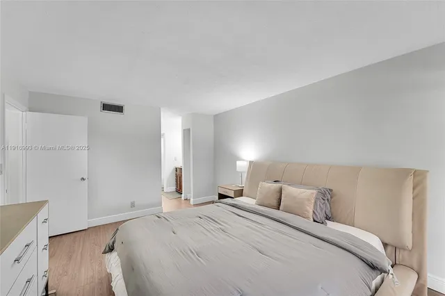 a bed room with a bed and a night stand