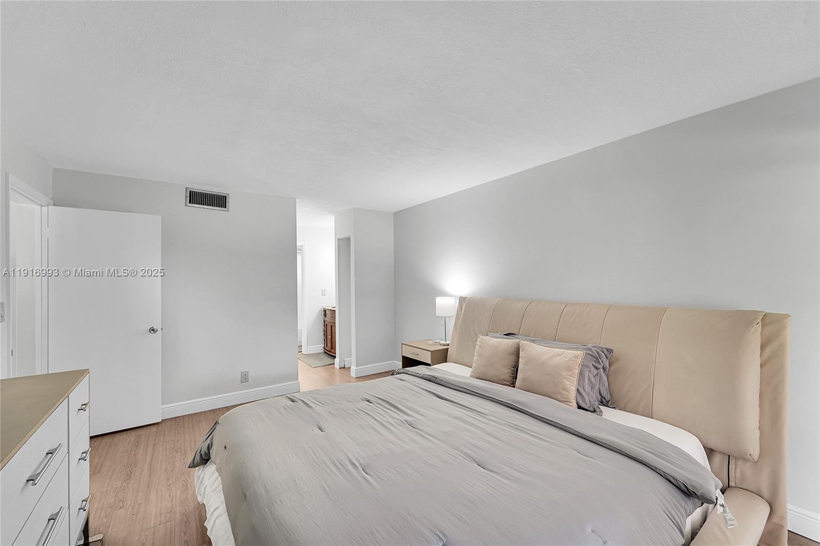 8405 Northwest 61st Street, Unit D207 Tamarac, FL 33321 - Photo 8 of 28 a bed room with a bed and a night stand