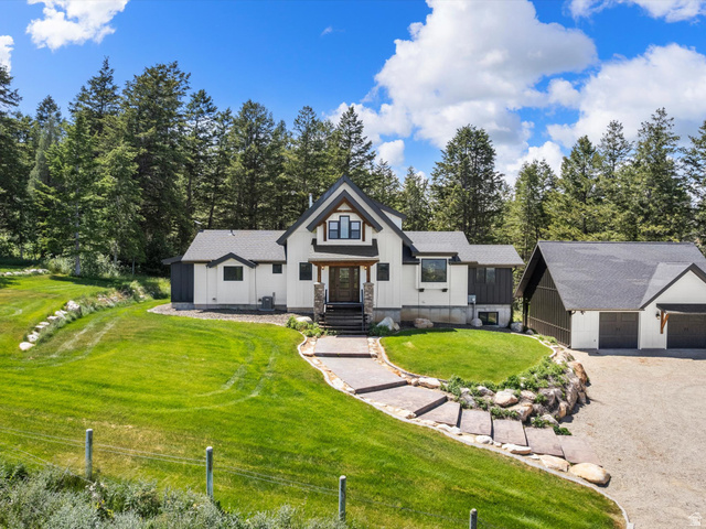 1225 Old Oregon Road Soda Springs, ID 83276 - Photo 55 of 67 Modern farmhouse-style residence with a two-car garage, set against a backdrop of mature trees