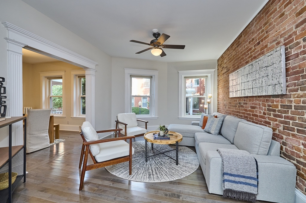5 Auburn Court, Unit 1 Brookline, MA 02446 - Photo 1 of 22 a living room with furniture and a window