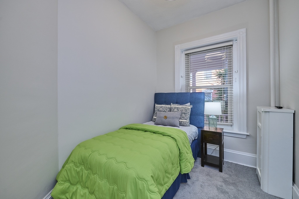5 Auburn Court, Unit 1 Brookline, MA 02446 - Photo 16 of 22 a bedroom with a bed and a window