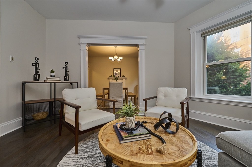 5 Auburn Court, Unit 1 Brookline, MA 02446 - Photo 3 of 22 a living room with furniture a window and a table