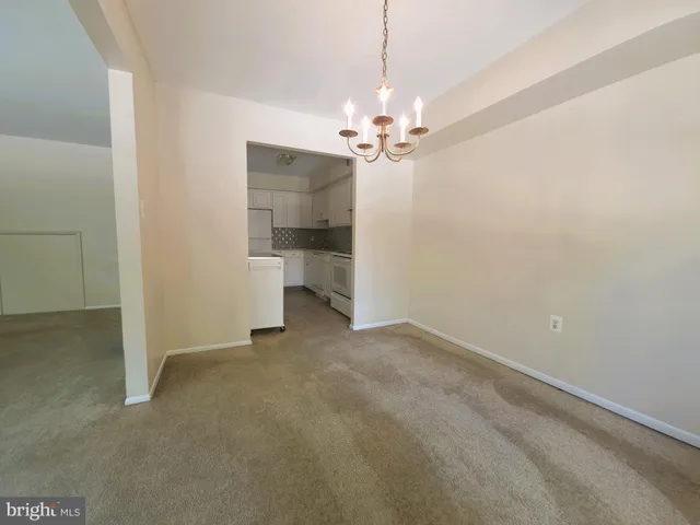 wooden floor in an empty room with a bathroom