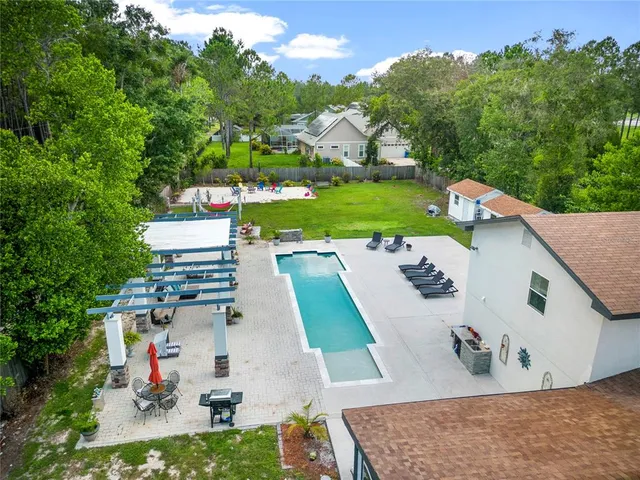 an aerial view of a house with outdoor space pool patio and outdoor seating