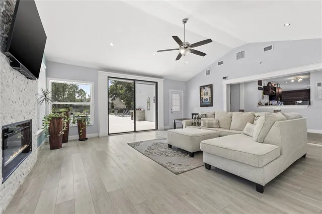 a living room with fireplace furniture and a flat screen tv