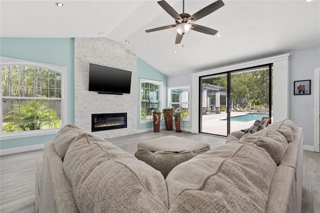 a living room with a large bed and a fireplace