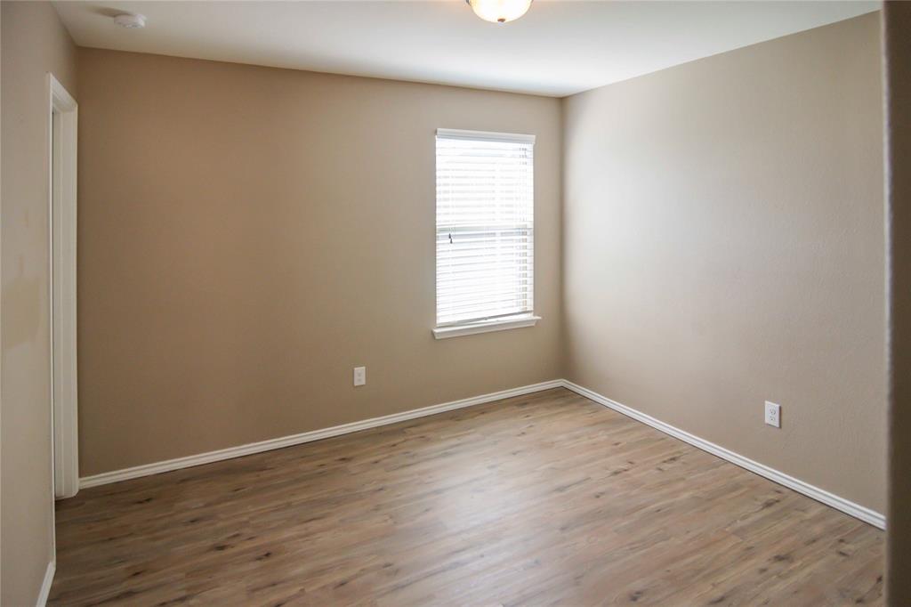 1044 Clove Hitch Road Georgetown, TX 78633 - Photo 10 of 19 an empty room with wooden floor and windows