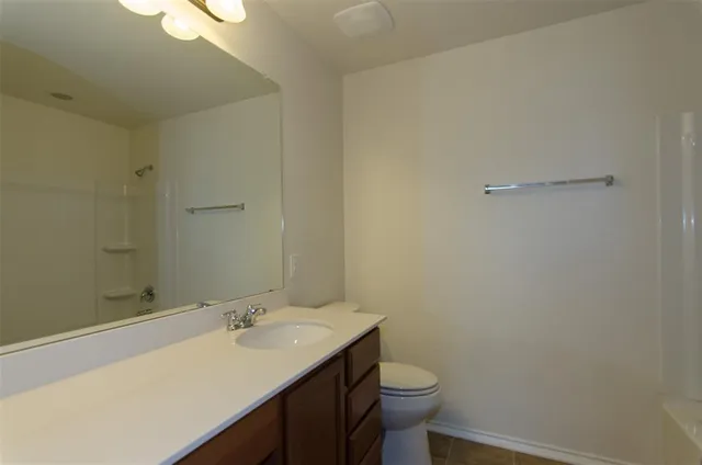 a bathroom with a bathtub and shower
