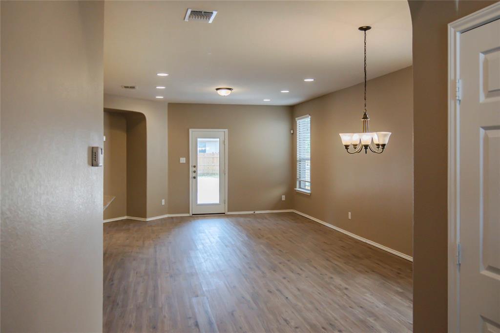 1044 Clove Hitch Road Georgetown, TX 78633 - Photo 16 of 19 a view of an empty room with wooden floor and a window