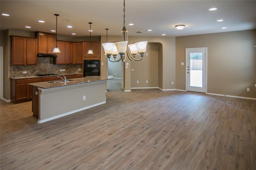 1044 Clove Hitch Road Georgetown, TX 78633 - Photo 19 of 19 a view of kitchen with kitchen island wooden floor appliances and living room