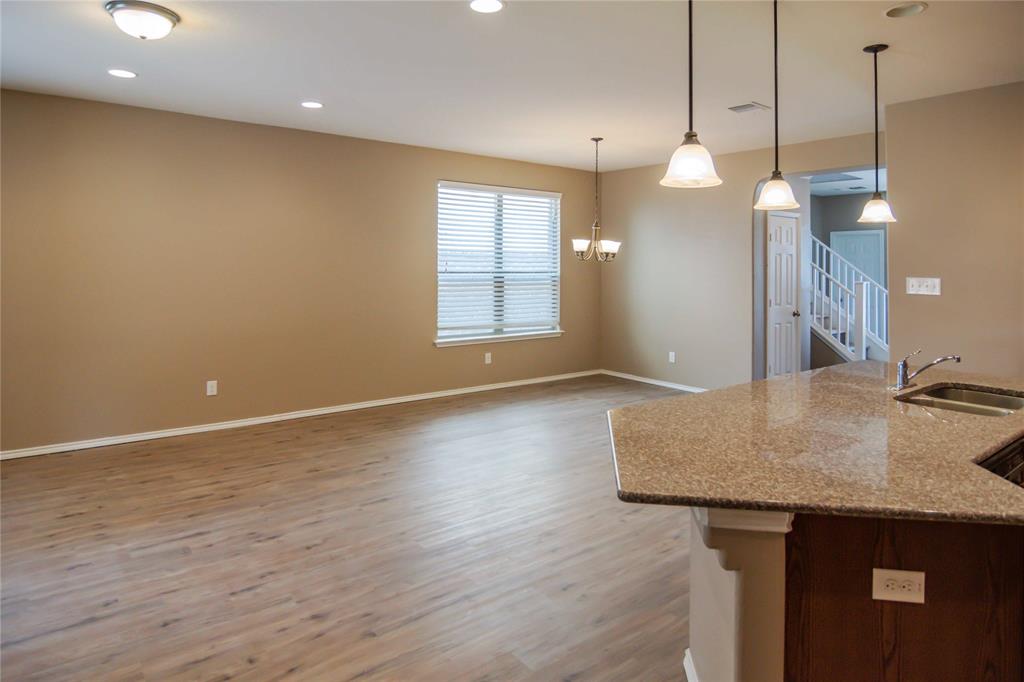 1044 Clove Hitch Road Georgetown, TX 78633 - Photo 4 of 19 a view of a kitchen with kitchen island a sink wooden floor and glass window