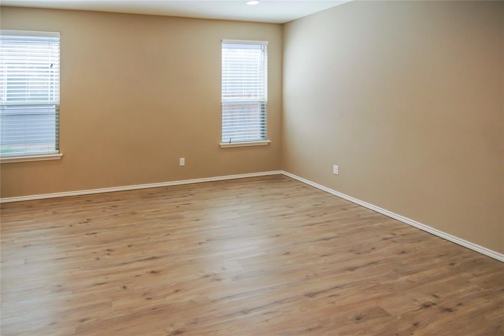 1044 Clove Hitch Road Georgetown, TX 78633 - Photo 6 of 19 a view of an empty room with wooden floor and a window