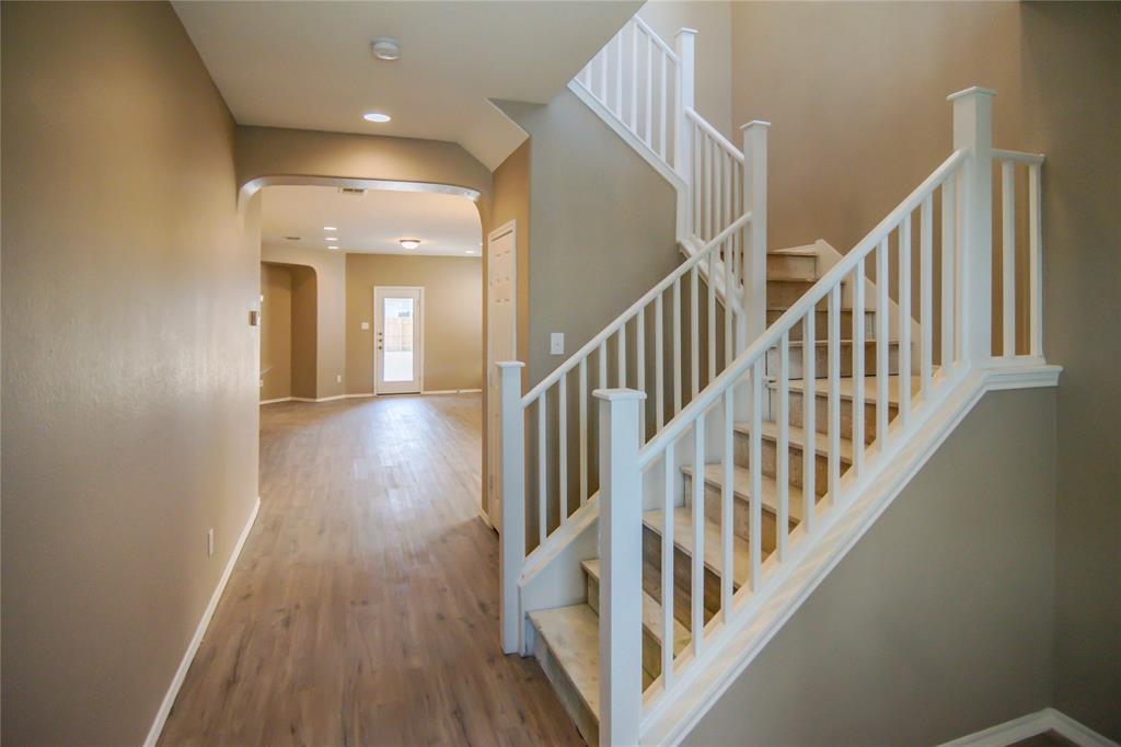 1044 Clove Hitch Road Georgetown, TX 78633 - Photo 7 of 19 a view of staircase with lots of frames on wall and wooden floor