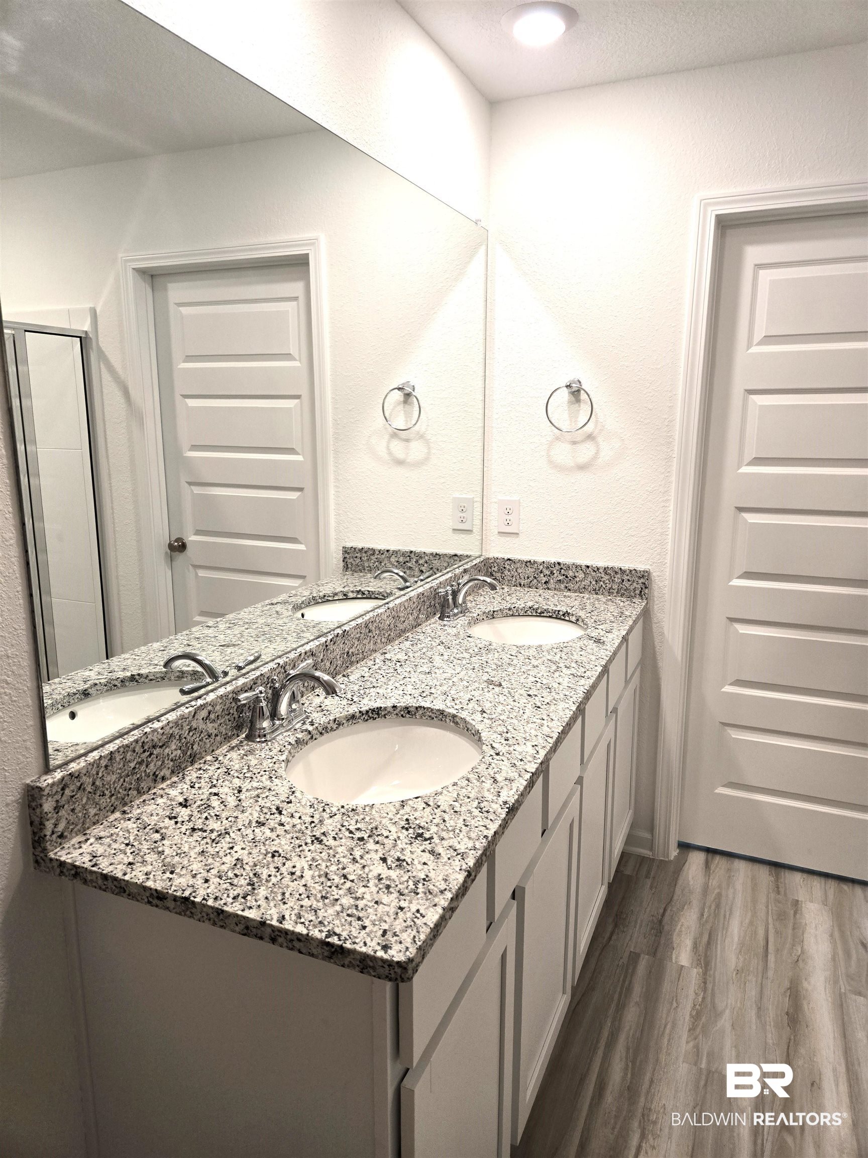 24385 Ringneck Loop Elberta, AL 36530 - Photo 16 of 33 Bathroom featuring hardwood / wood-style flooring, a shower with door, and vanity
