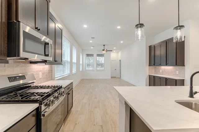 a kitchen with stainless steel appliances granite countertop a stove and a sink