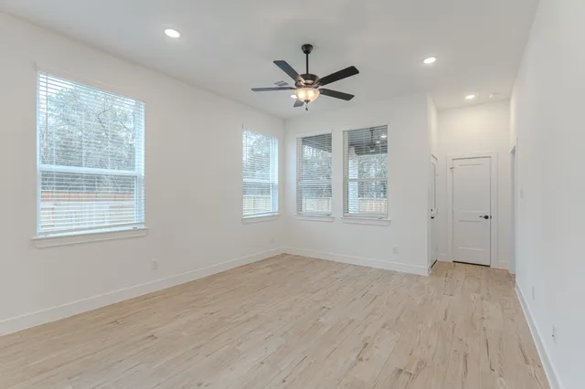 wooden floor in an empty room with a window