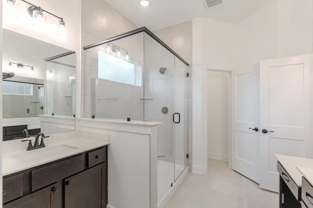 a bathroom with a sink double vanity and a mirror